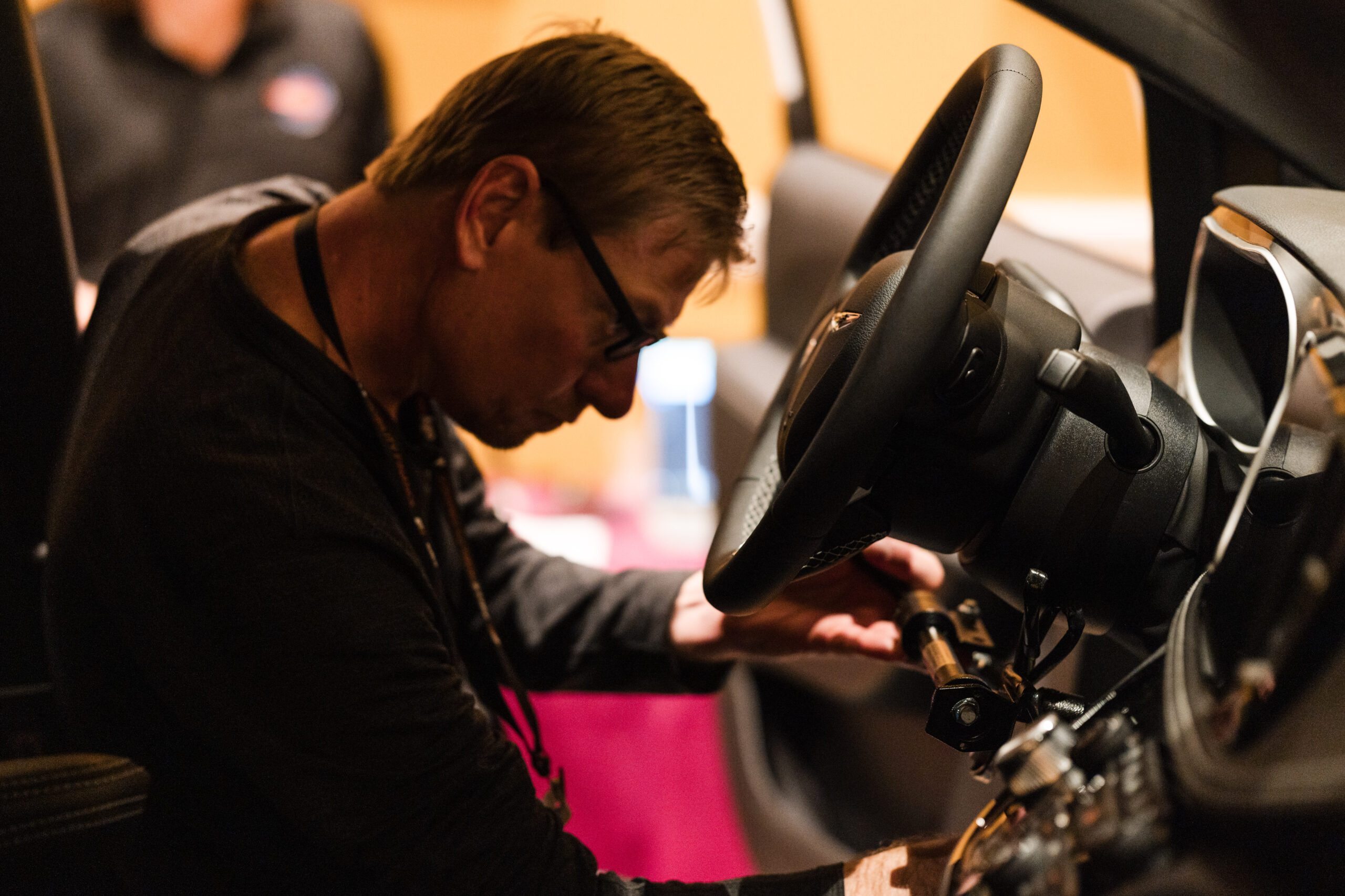 Technician working hands-on with mobility equipment at the NMEDA Conference & Expo technician training